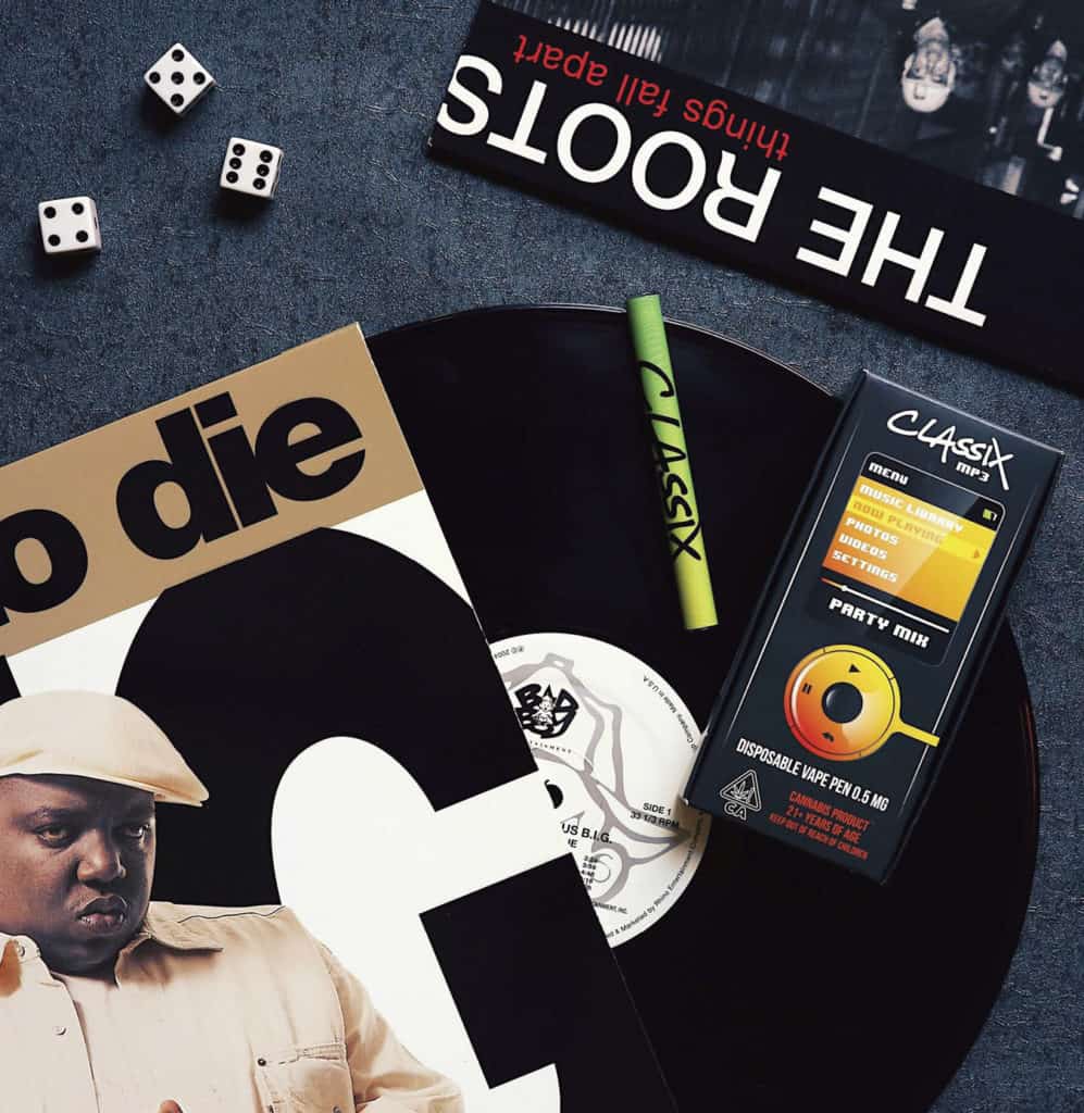 A cannabis brand called Classix laid out on the table with various dice and vinyl records