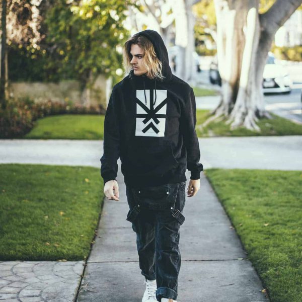 A man posing with a Project Cannabis Los Angeles hoodie