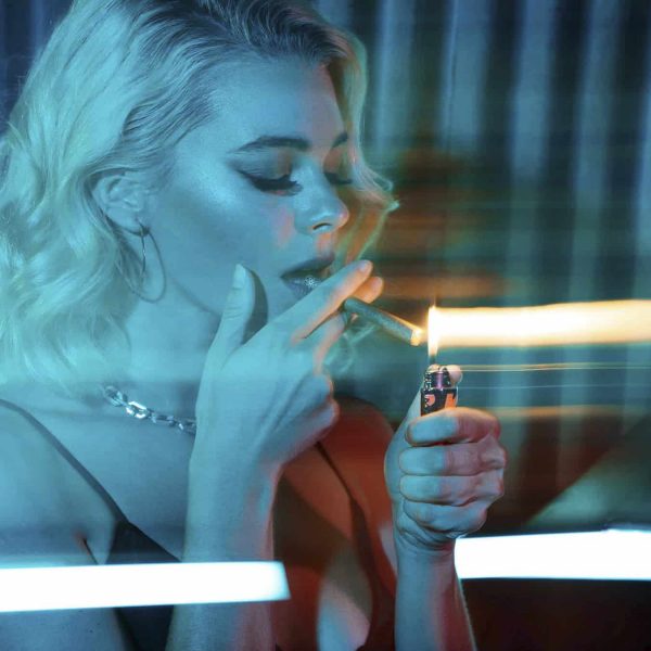 girl posing with lighting cannabis